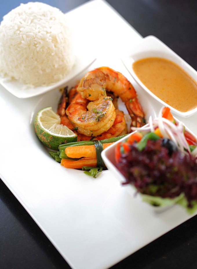 Plated prawns with rice, vegetables and salad